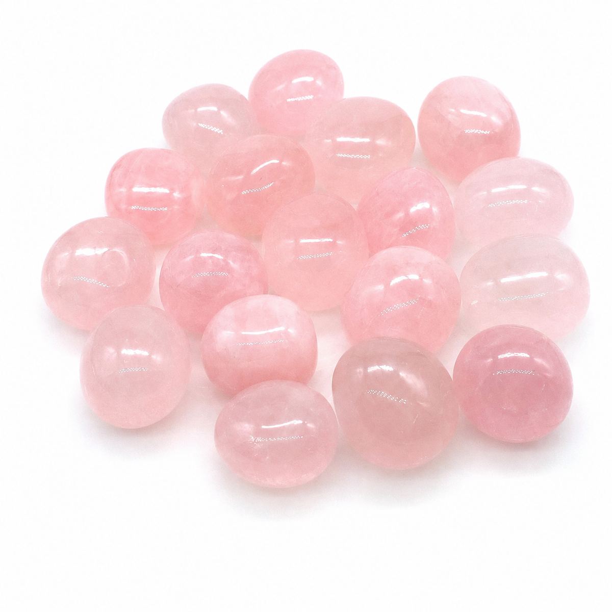 Polished pale pink Rose Quartz tumbled stones on a white background