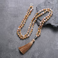 Full Citrine tassel mala arranged on a dark gray background.