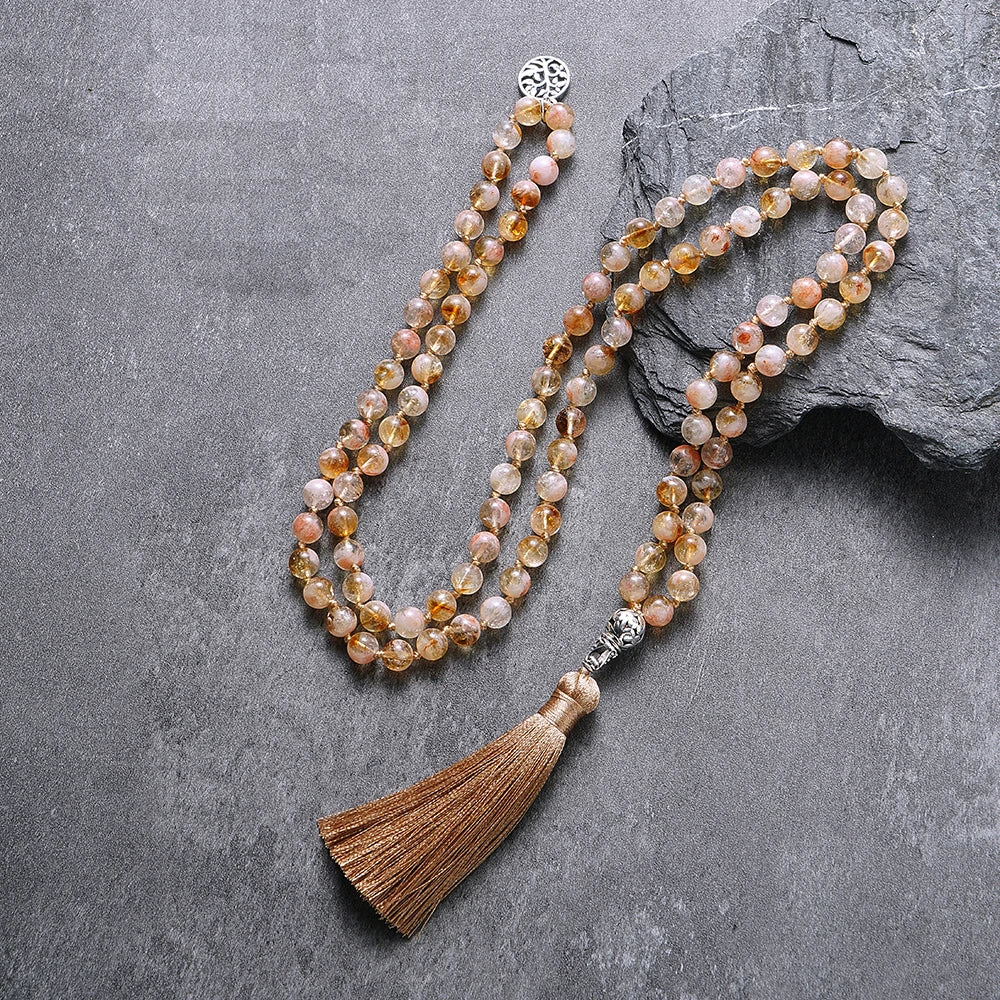Full Citrine tassel mala arranged on a dark gray background.