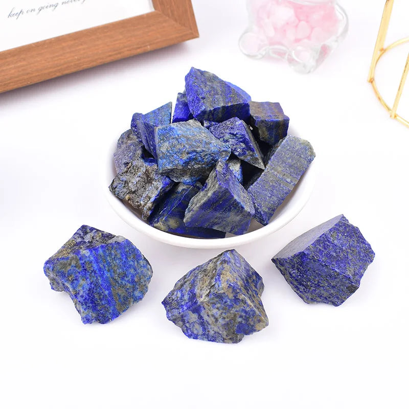 Rough Lapis Lazuli chunks arranged beside a small white bowl.