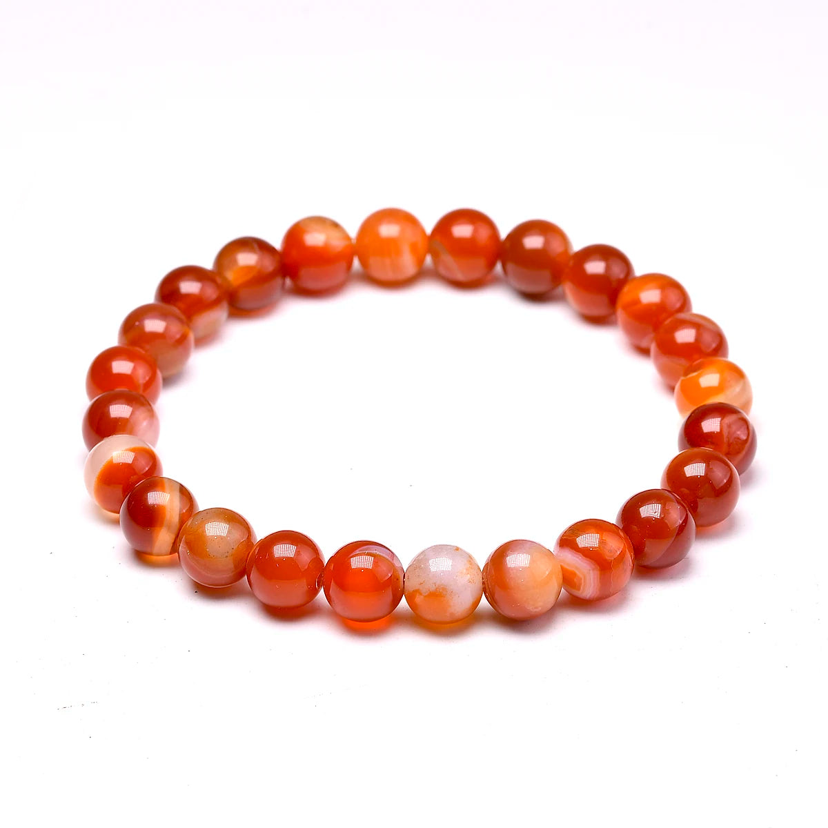 Close product view of an orange Carnelian round-bead bracelet on white.