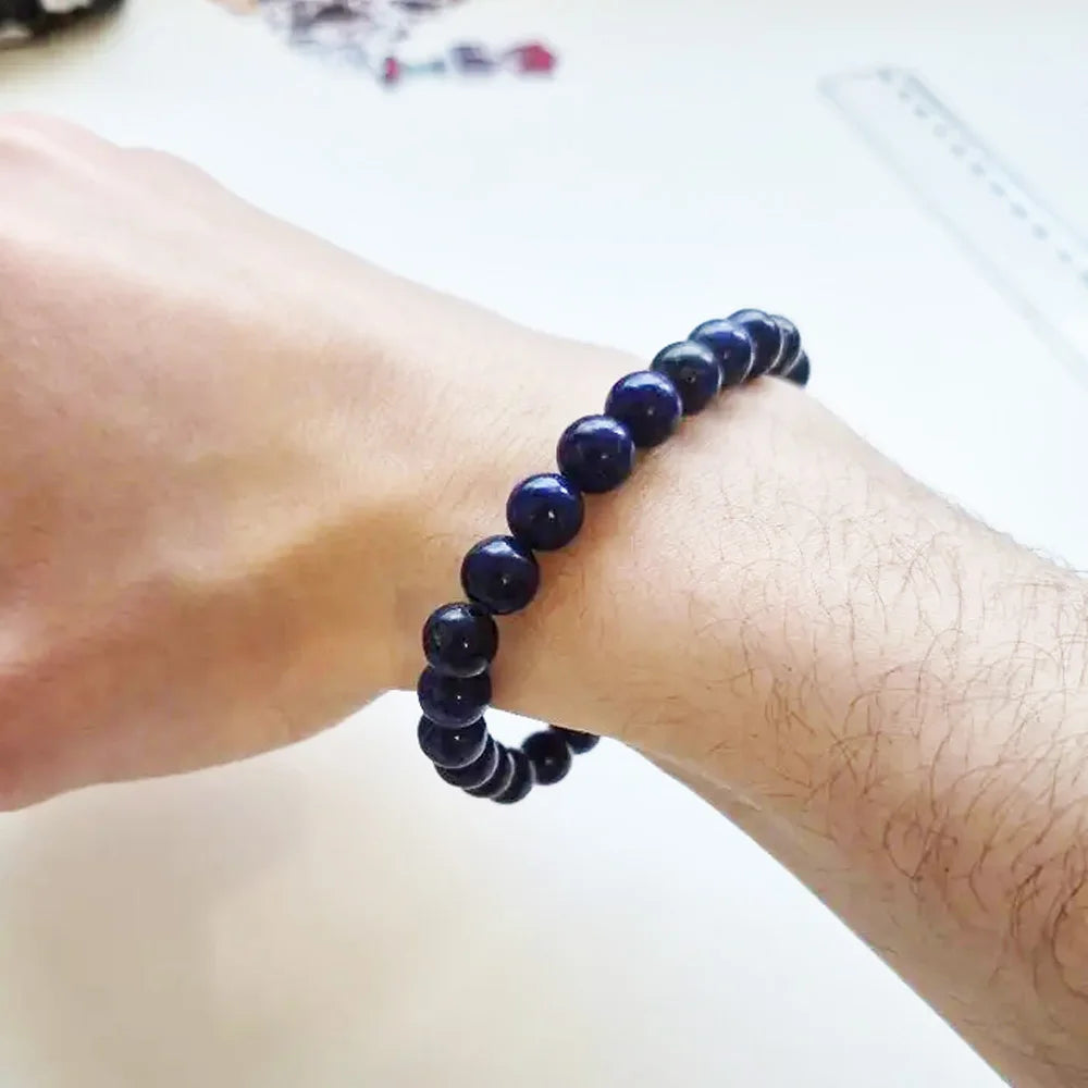 Lapis Lazuli bead bracelet worn on a wrist.