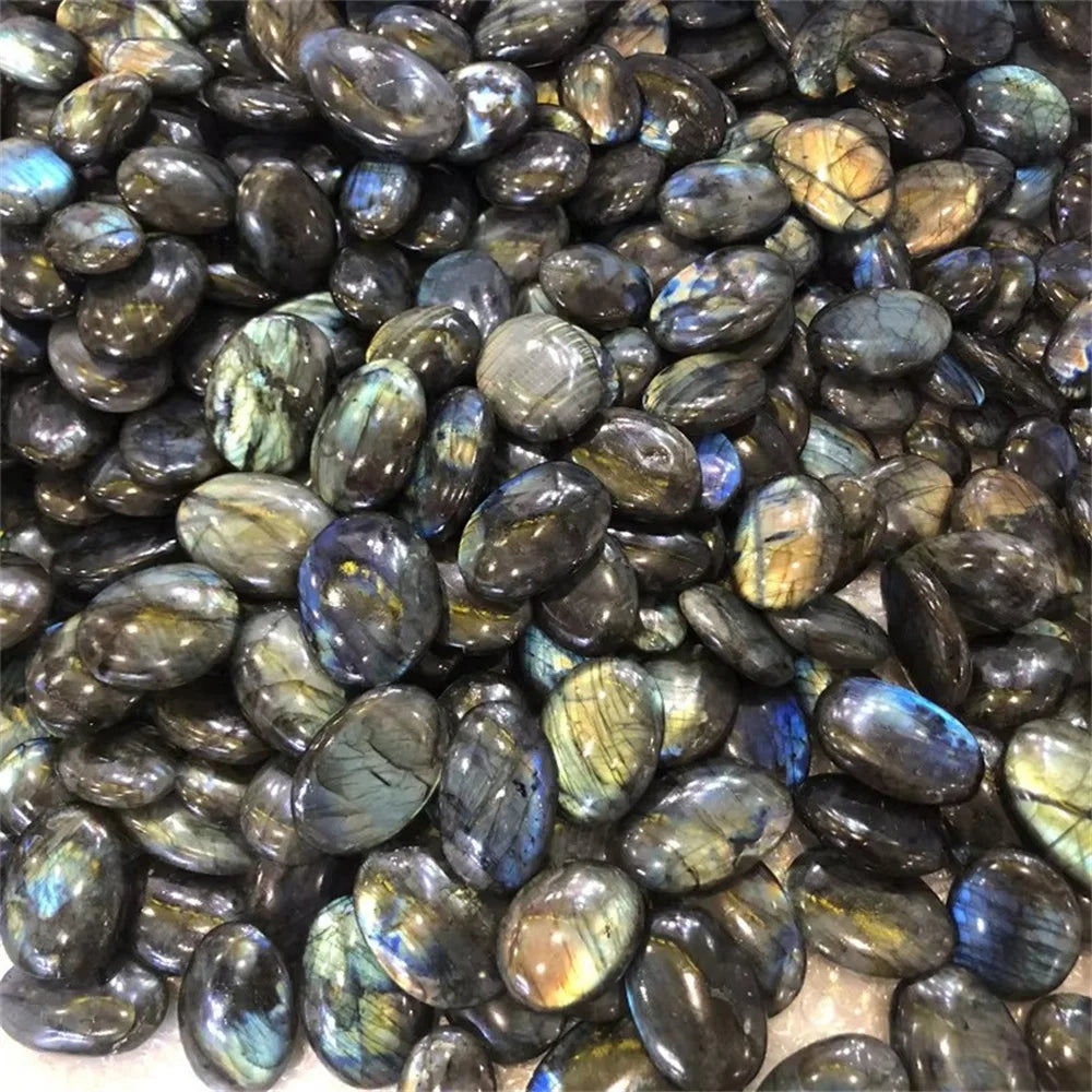 Large assortment of Labradorite tumbled stones showing varied natural flash patterns.