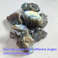 Assorted rough Labradorite pieces showing blue and gold flashes, with angle-view guidance printed below.