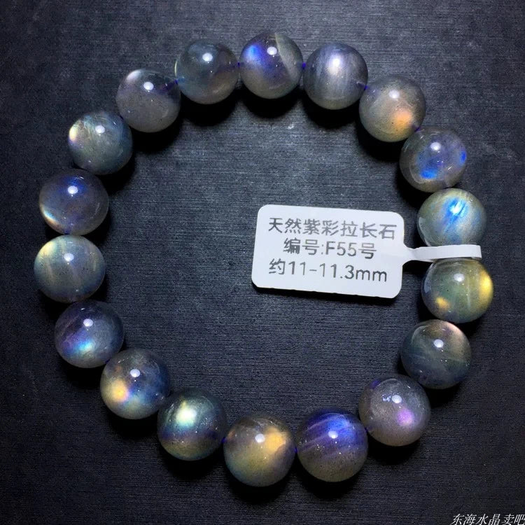 Labradorite round-bead bracelet on black with an identification label inside the circle.