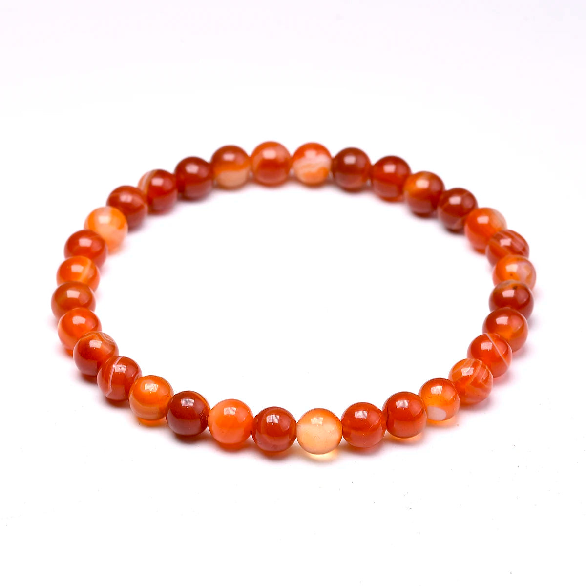 Carnelian round-bead bracelet isolated on white, alternate angle.