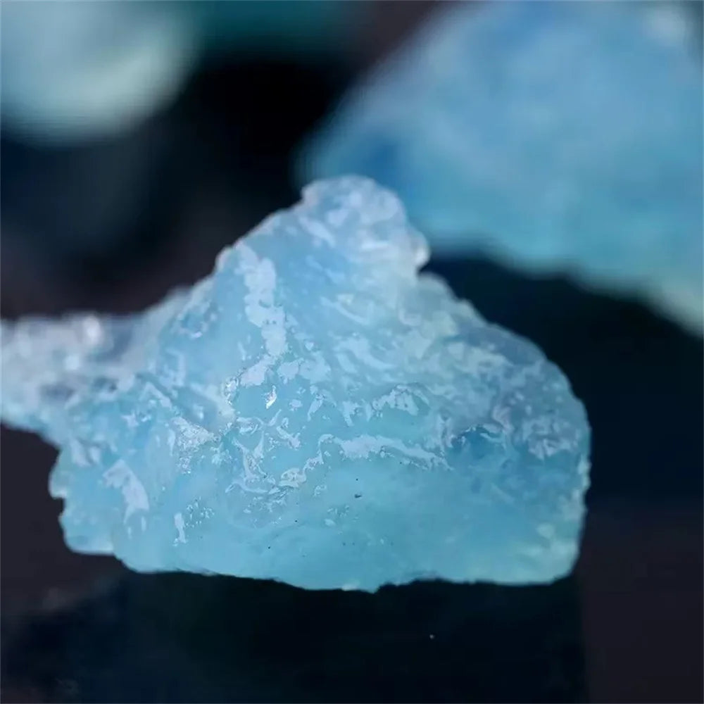 Close-up of a single rough pale blue Aquamarine crystal with natural texture.