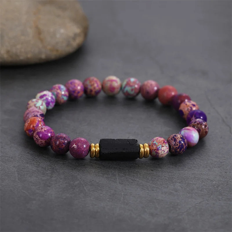 Bracelet style shown with purple multicolor beads and a black rectangular center stone.