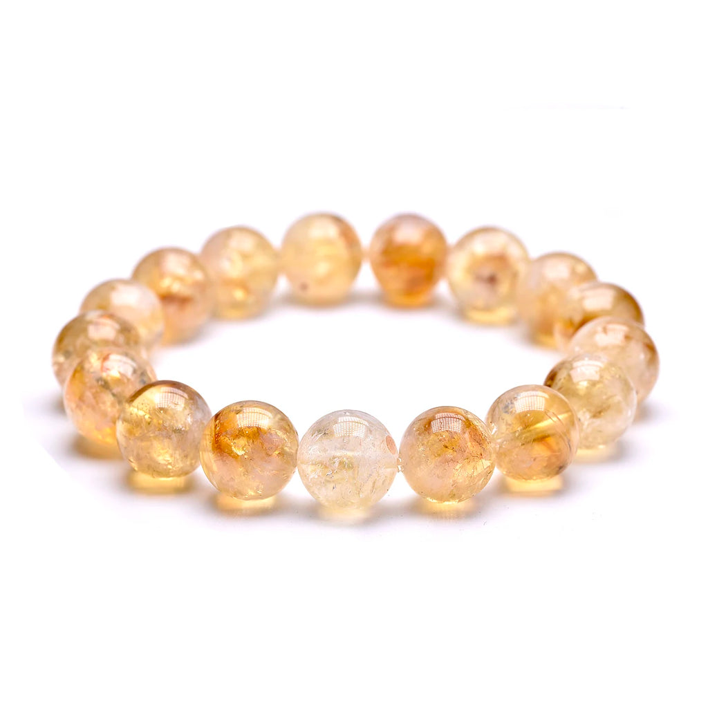 Citrine bead bracelet shown from a low angle on a white background.