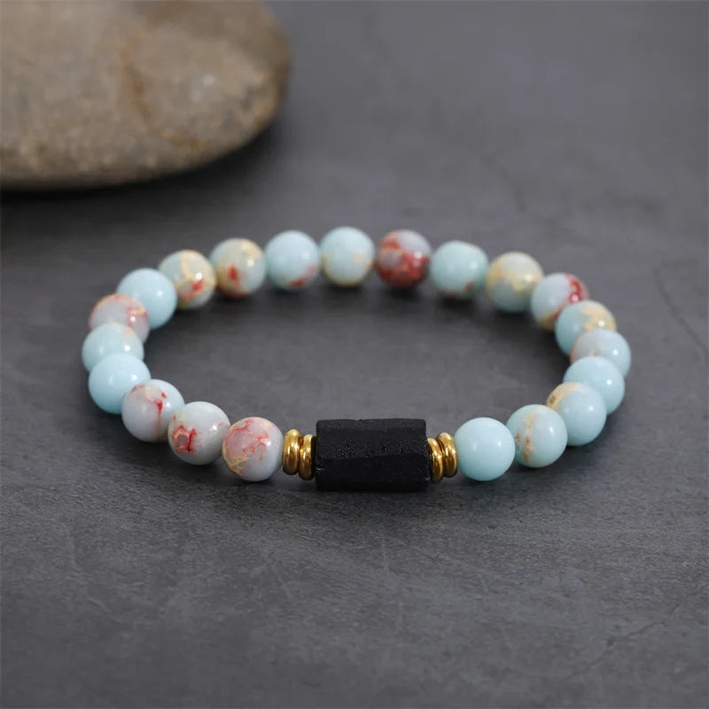 Bracelet style shown with pale multicolor beads and a black rectangular center stone.