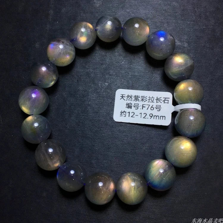 Labradorite bracelet on black showing varied iridescent flashes and a size label.