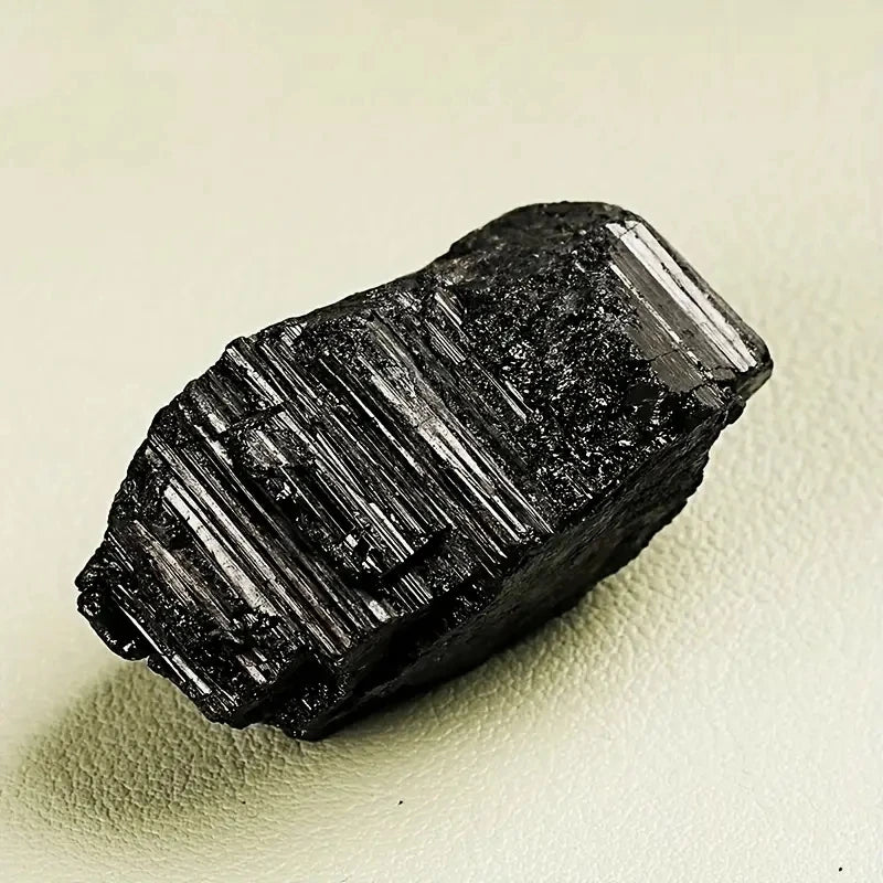 Single rough Black Tourmaline crystal showing natural vertical striations.