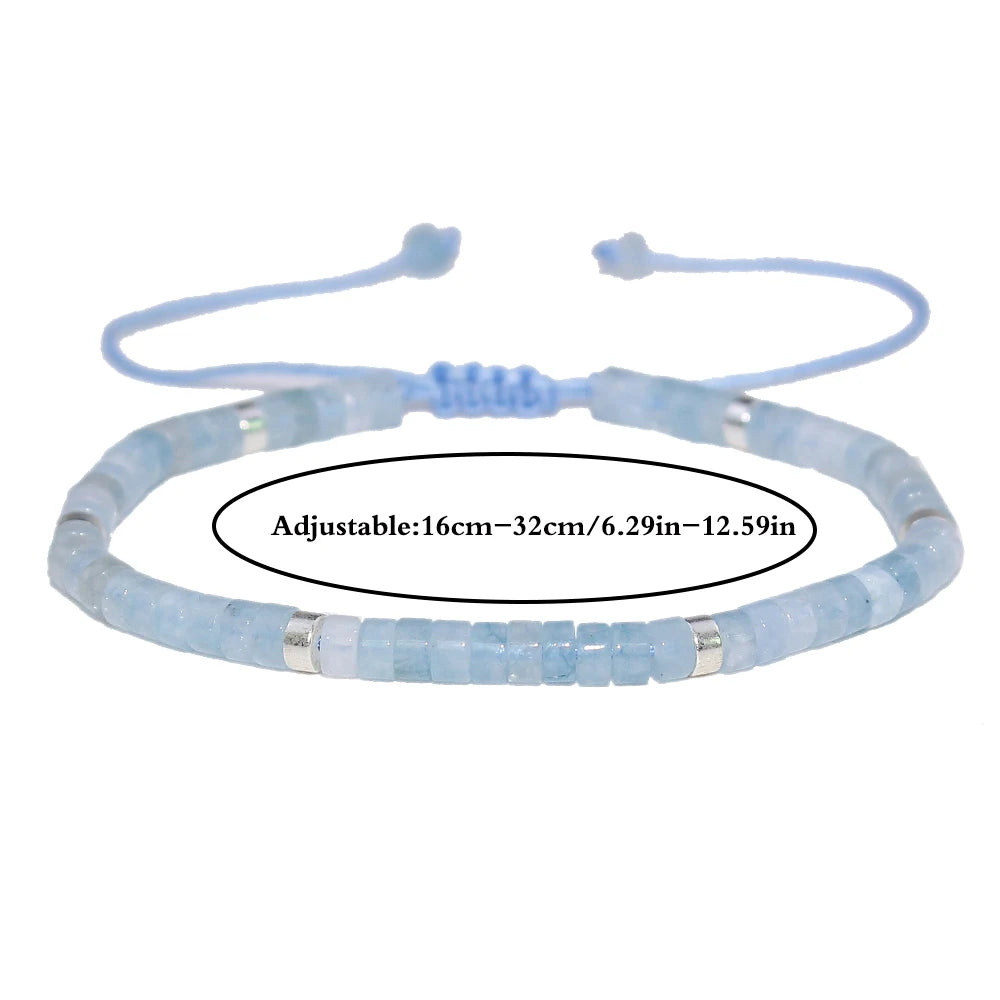 Aquamarine adjustable bracelet on white with the cord closure and size-range guide visible.