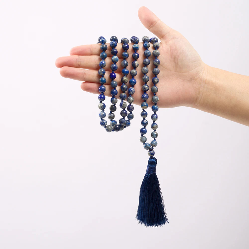 Lapis Lazuli tassel mala held across an open hand to show length and bead scale.