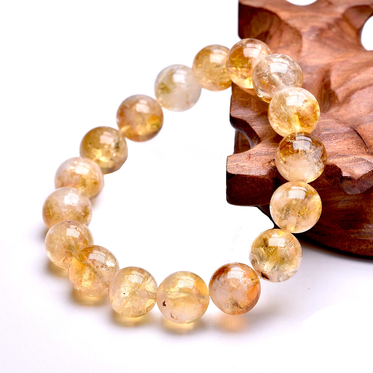 Golden Citrine bracelet displayed beside a natural wood accent.