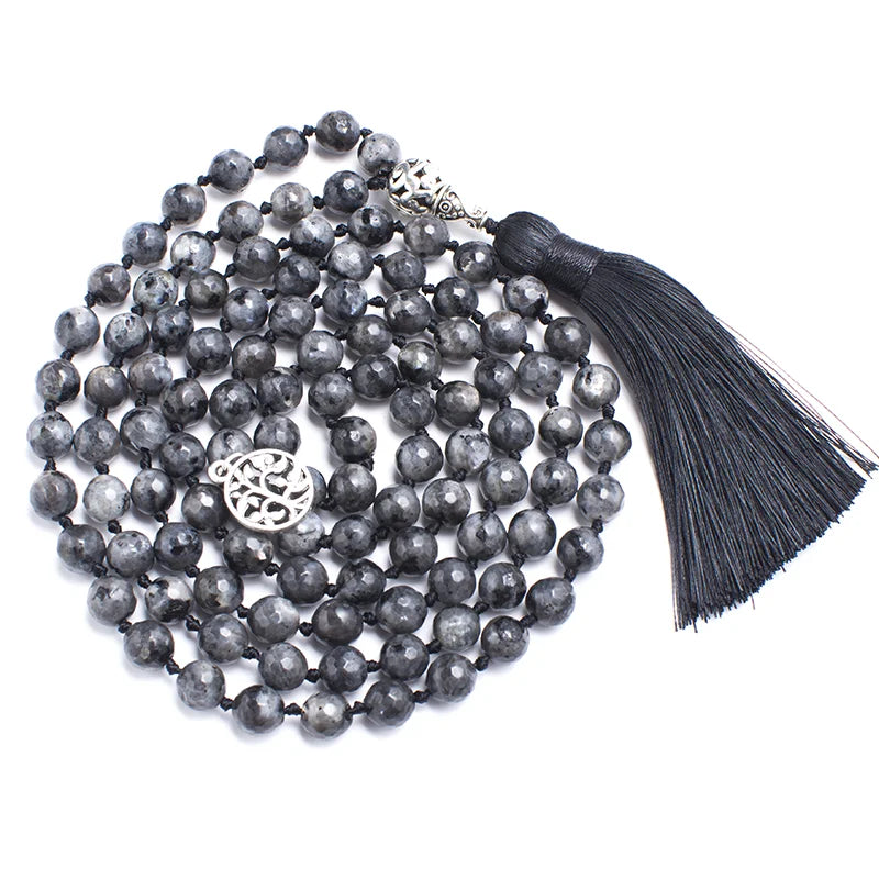 Labradorite tassel mala coiled densely on a white background.