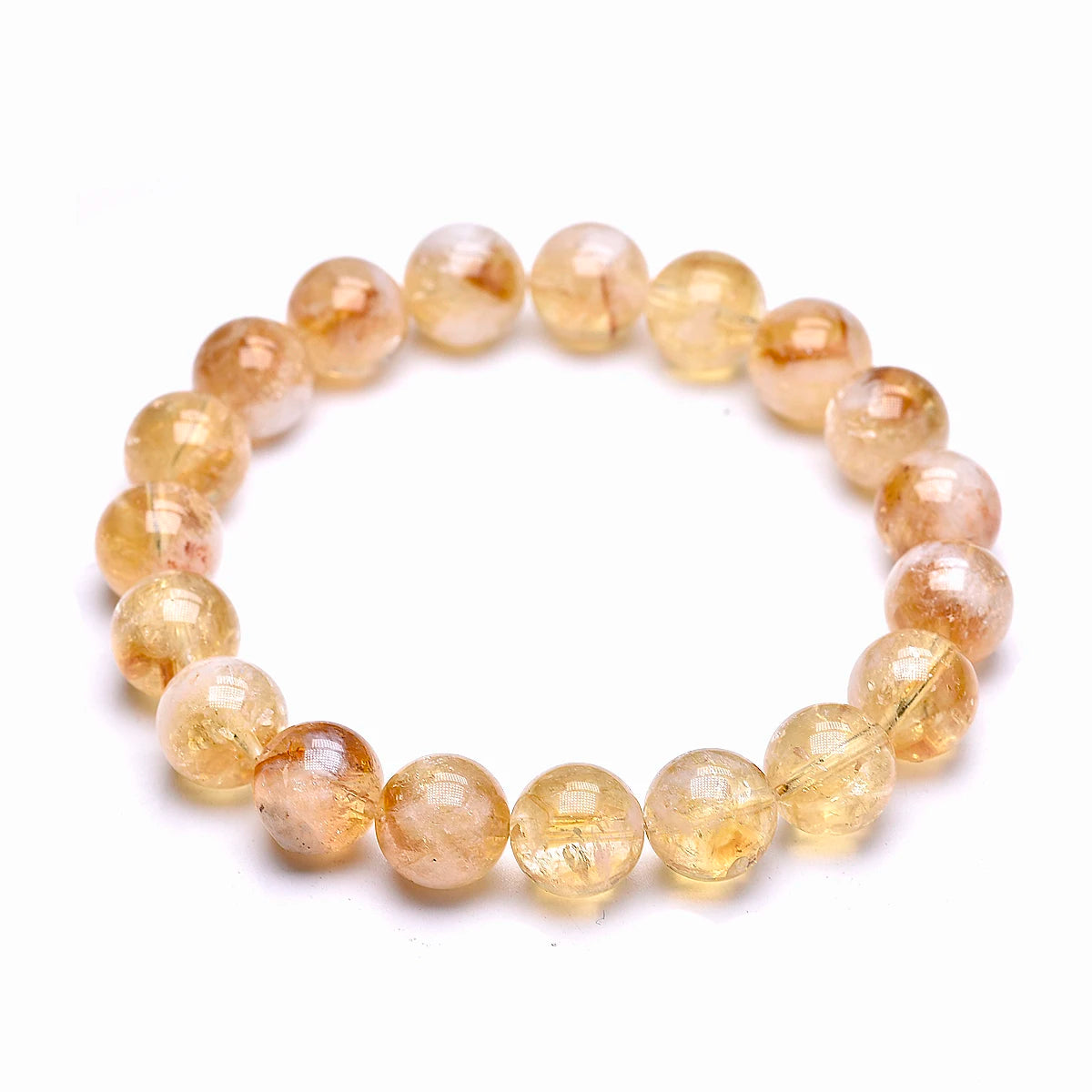Citrine bracelet with larger golden round beads shown on a white background.