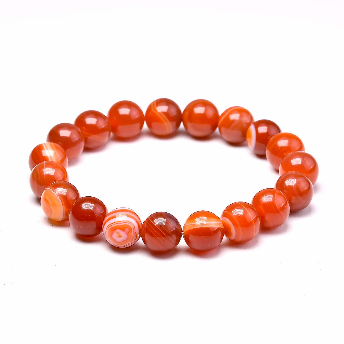 Orange-red Carnelian round-bead bracelet isolated on a white background.