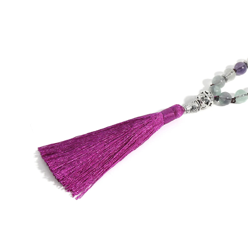 Close-up of the purple tassel and Fluorite beads at the end of the mala.